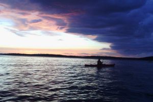 Kayaker with clouds rolling in